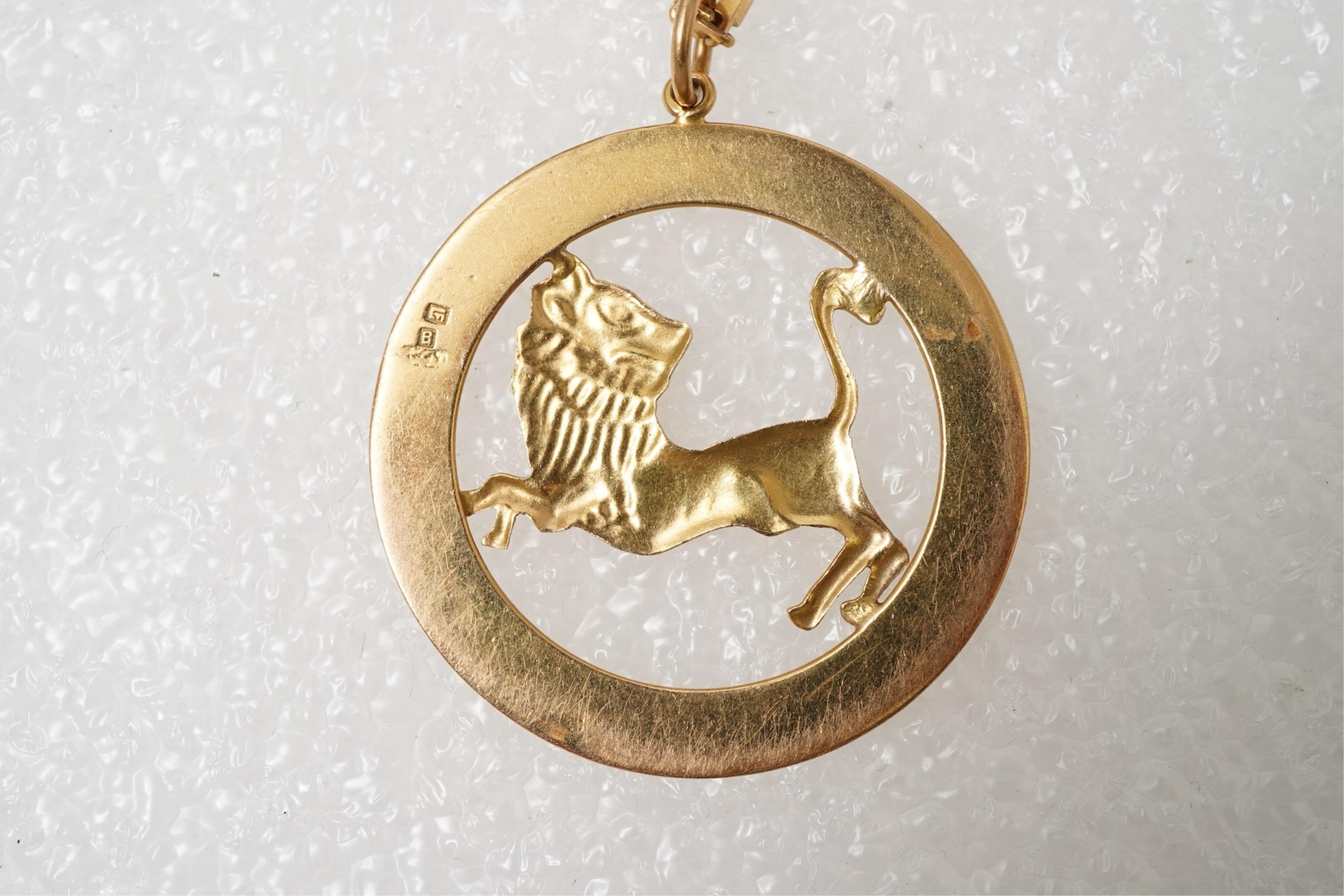 A gold zodiac pendant, mid 20th century